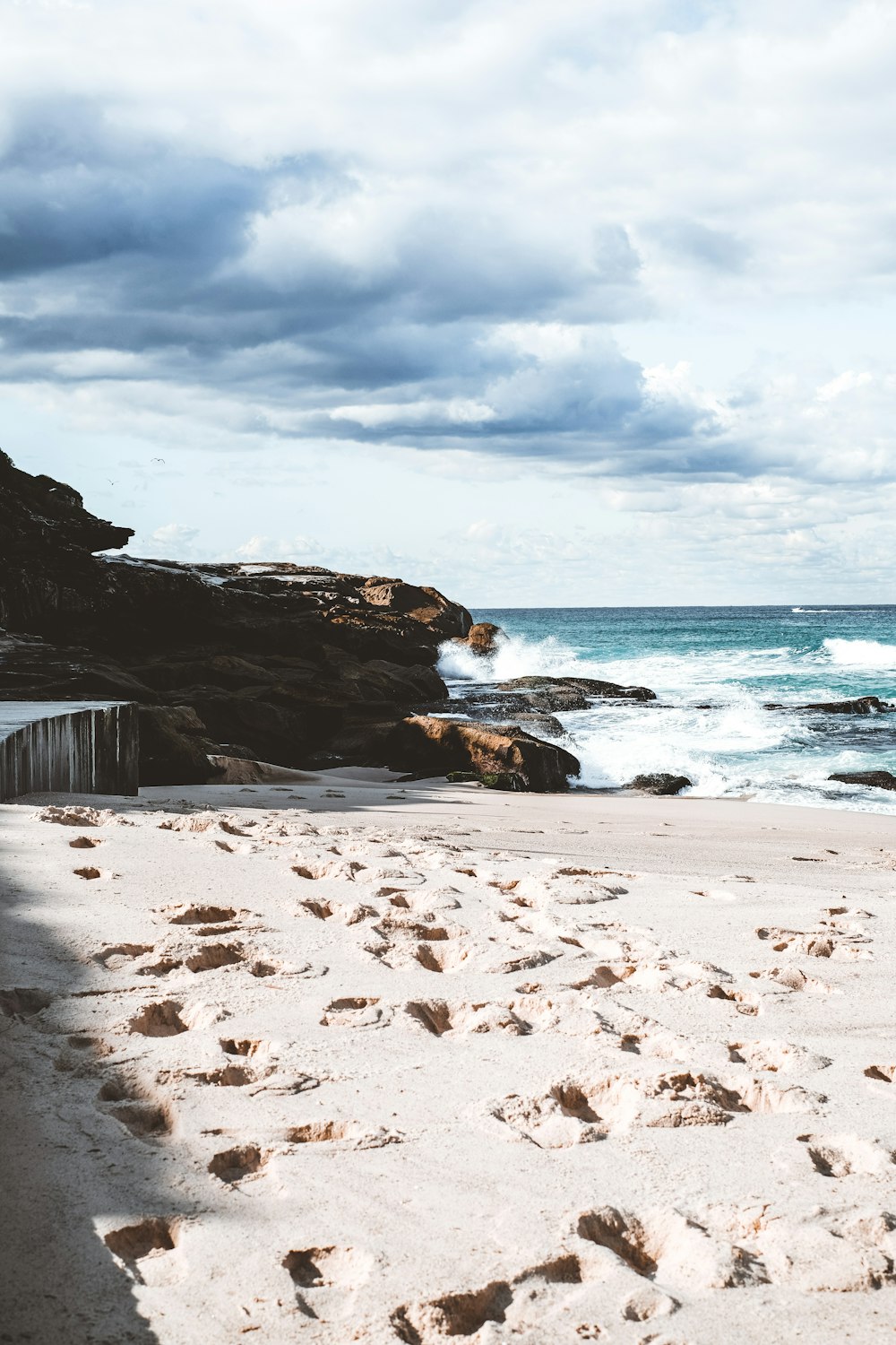 brown rocky beach shore under cloudy sky during daytime