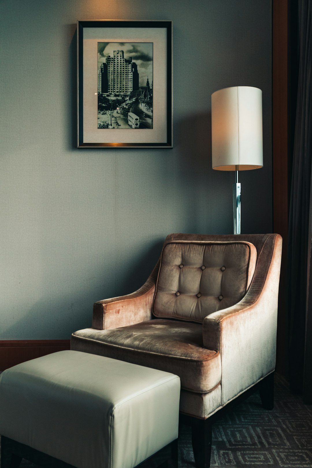 brown wooden framed white padded armchair