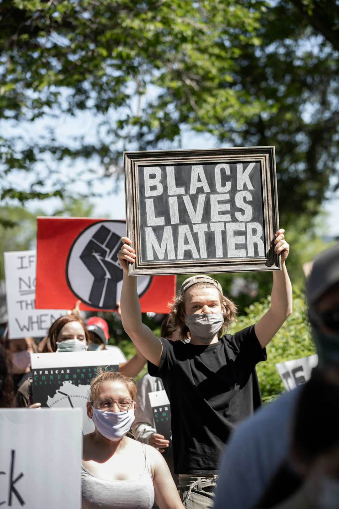 woman in black and white shirt holding a signage