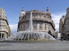 white concrete building with water fountain during daytime