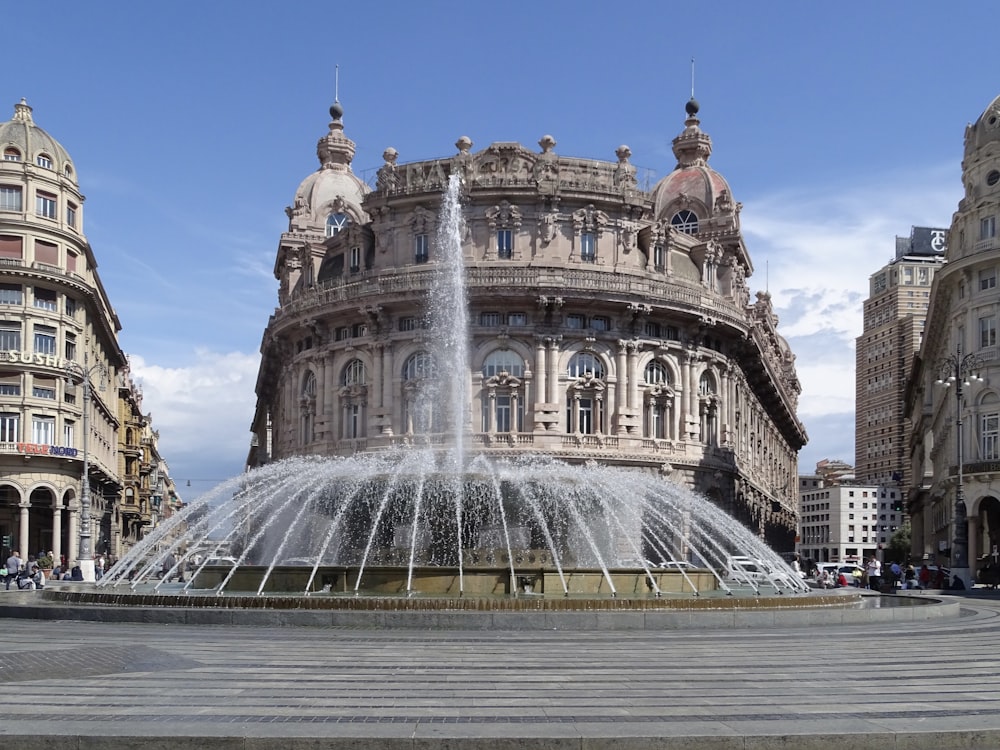 white concrete building with water fountain during daytime