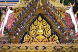 Intricate lotus mandala patterns carved into temple walls bathed in warm light.