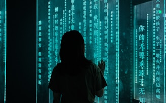 silhouette of woman standing in front of blue light