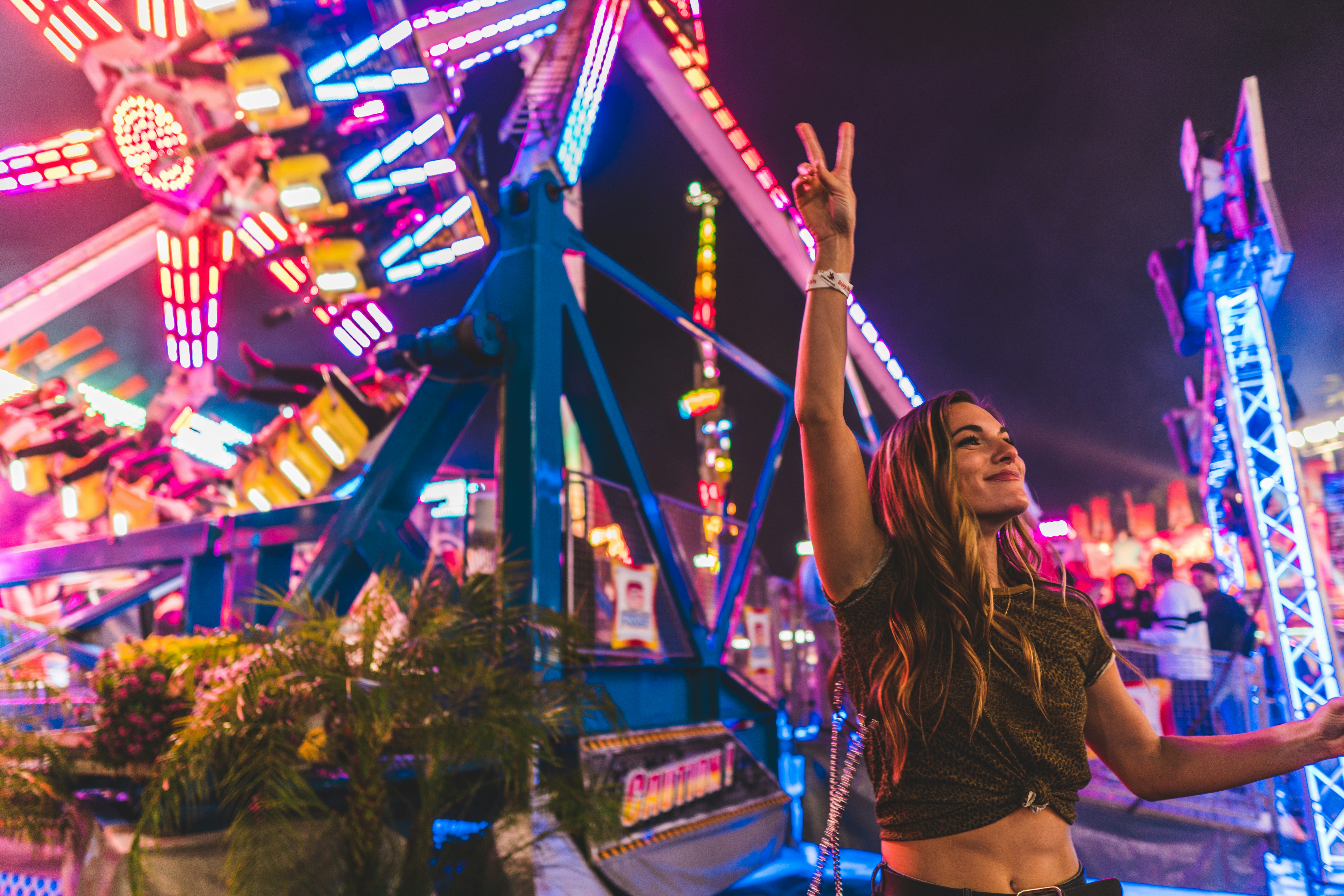 woman in red and white stripe shirt and black shorts standing near blue and red metal
