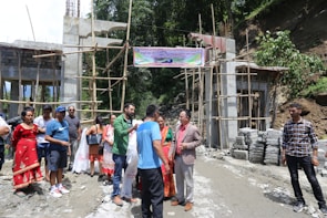 A group of international volunteers building housing structures together.
