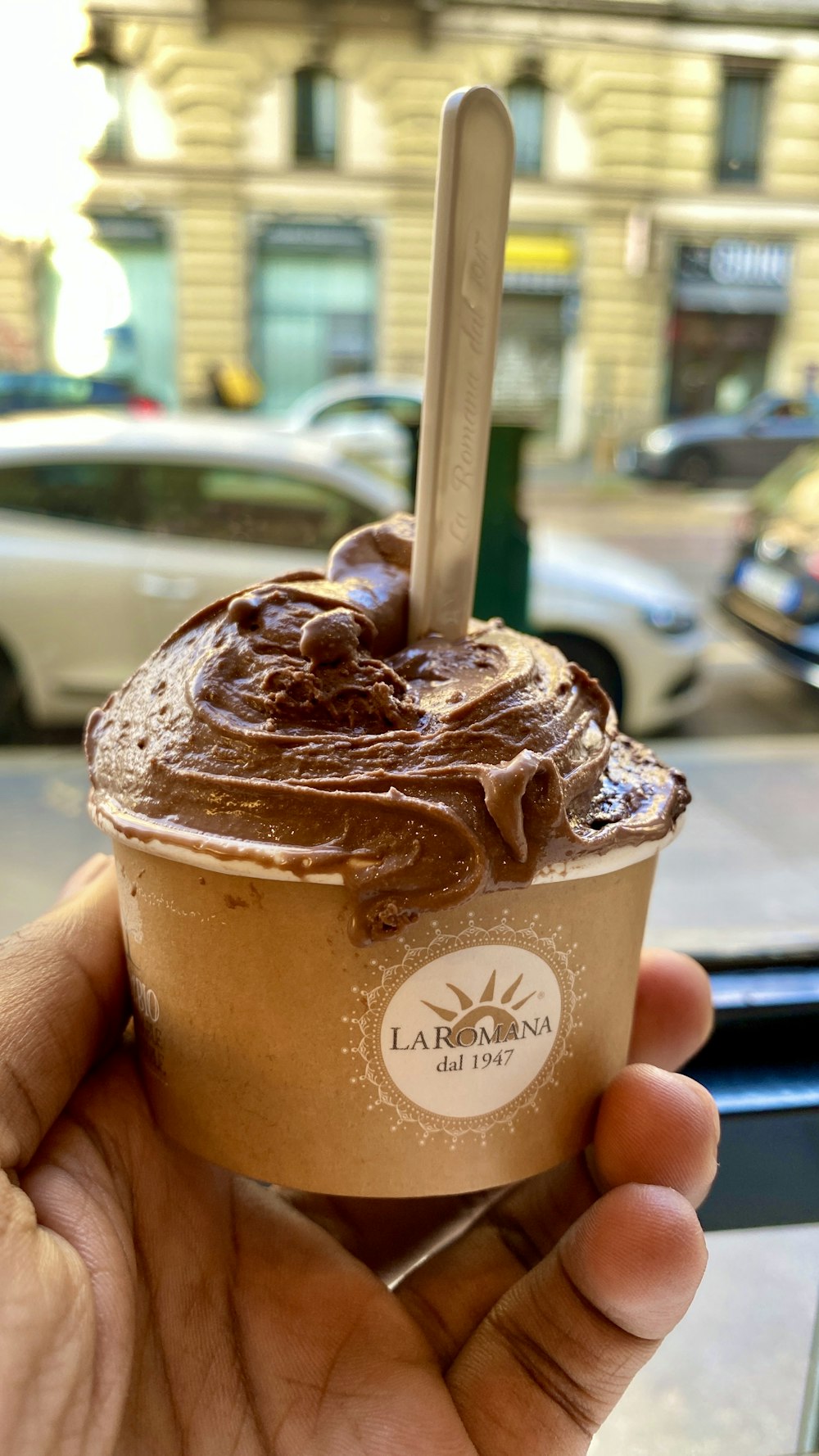 person holding brown ice cream cone