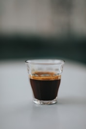 clear drinking glass with brown liquid