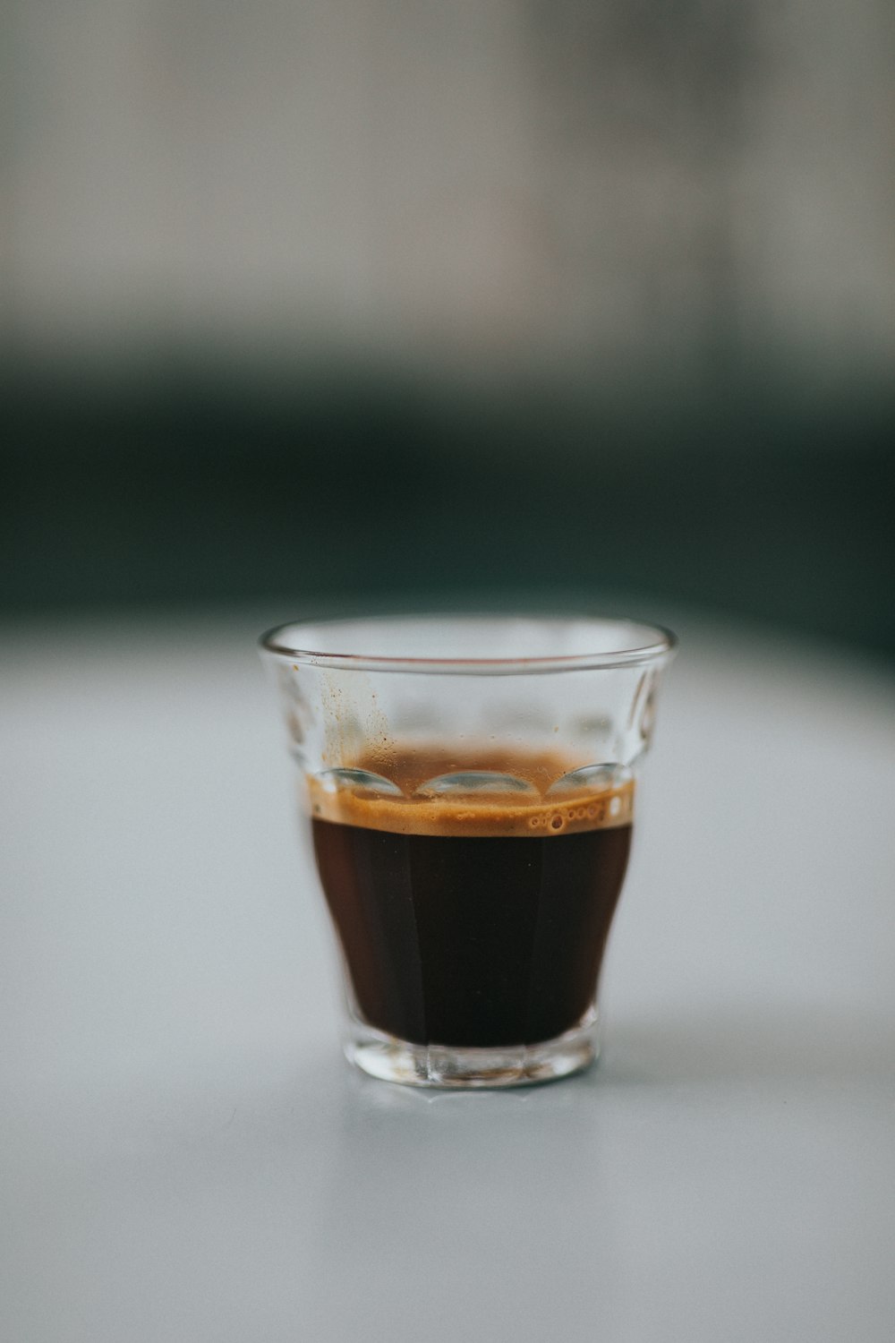 clear drinking glass with brown liquid