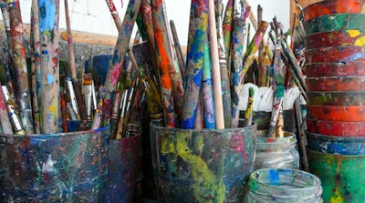 blue and red paint brush in blue bucket