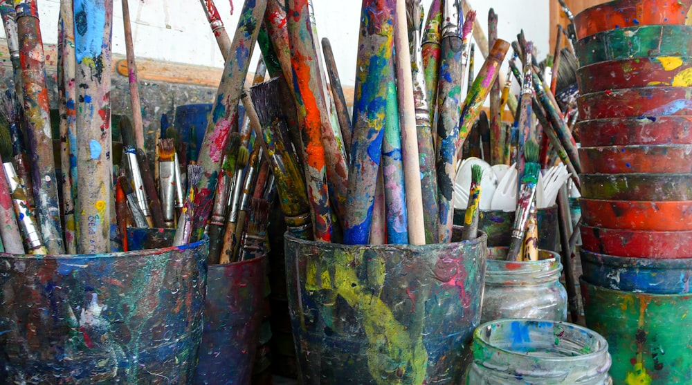 blue and red paint brush in blue bucket