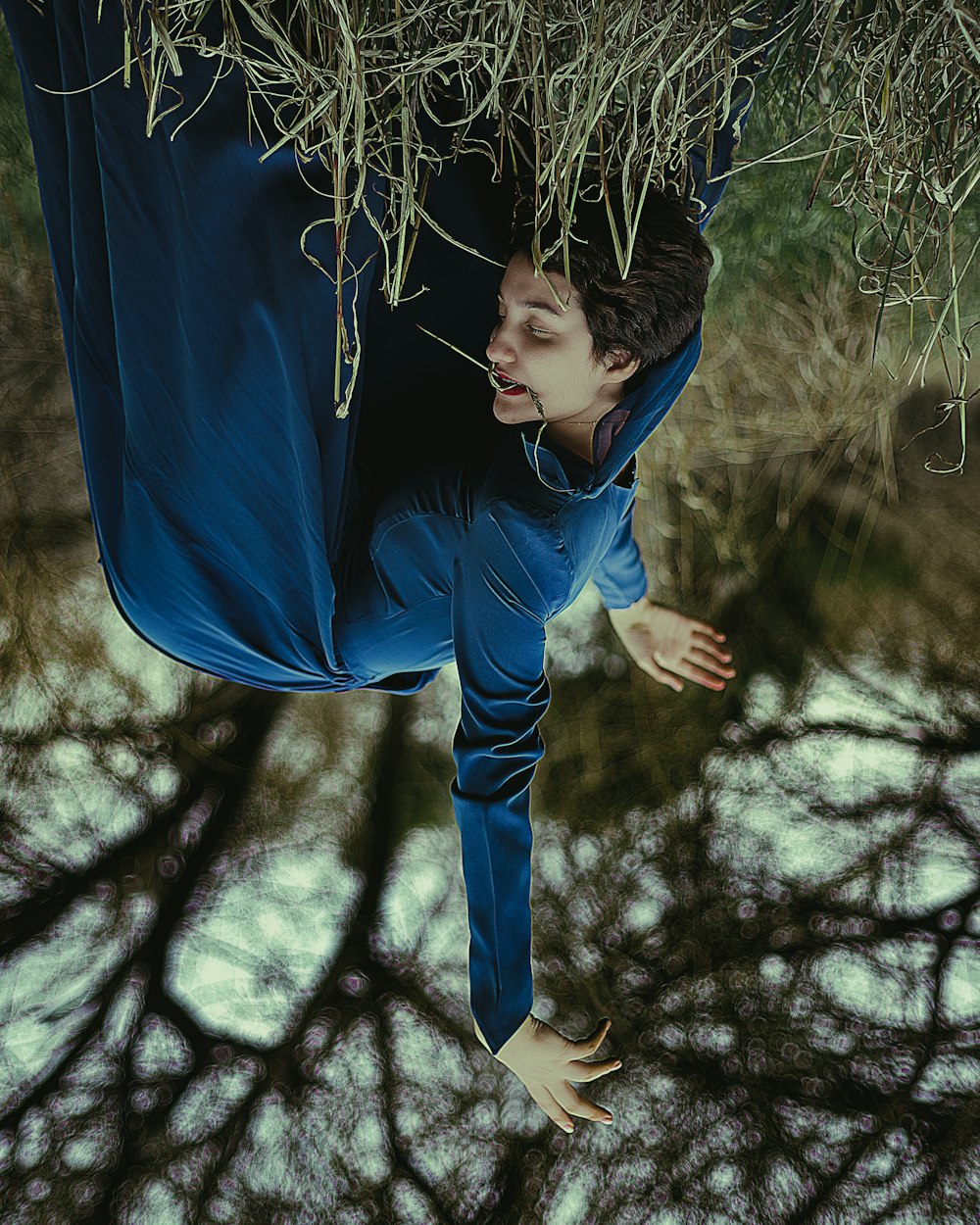 a man hanging upside down from a tree