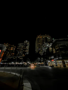 An evening cityscape shot showing soft glowing lights and a quiet rooftop workspace.