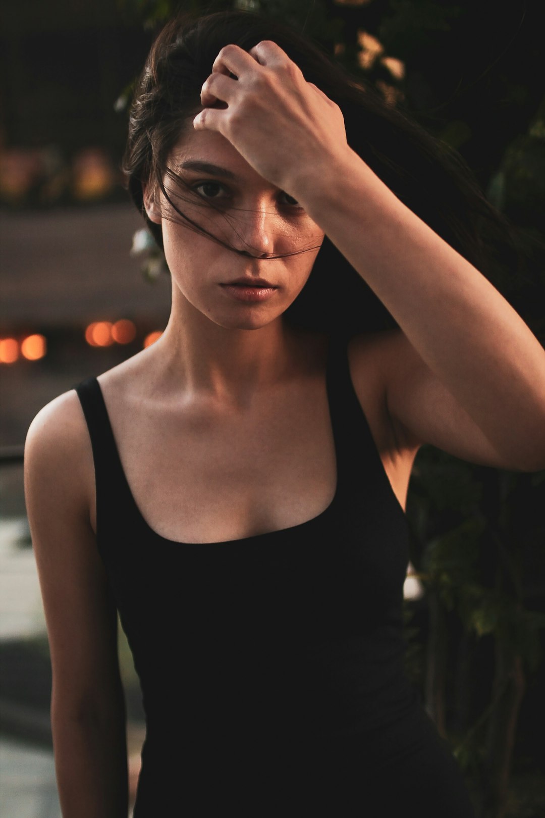 woman in black tank top wearing black framed eyeglasses