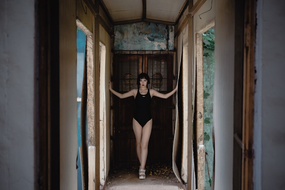 woman in black dress standing on doorway