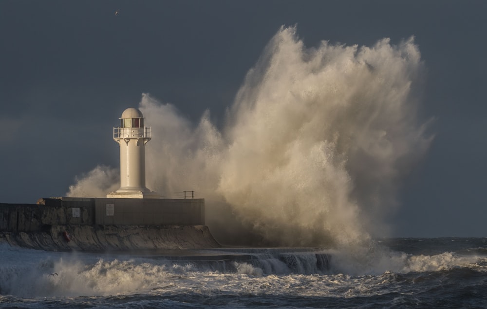 white and black lighthouse under blue sky