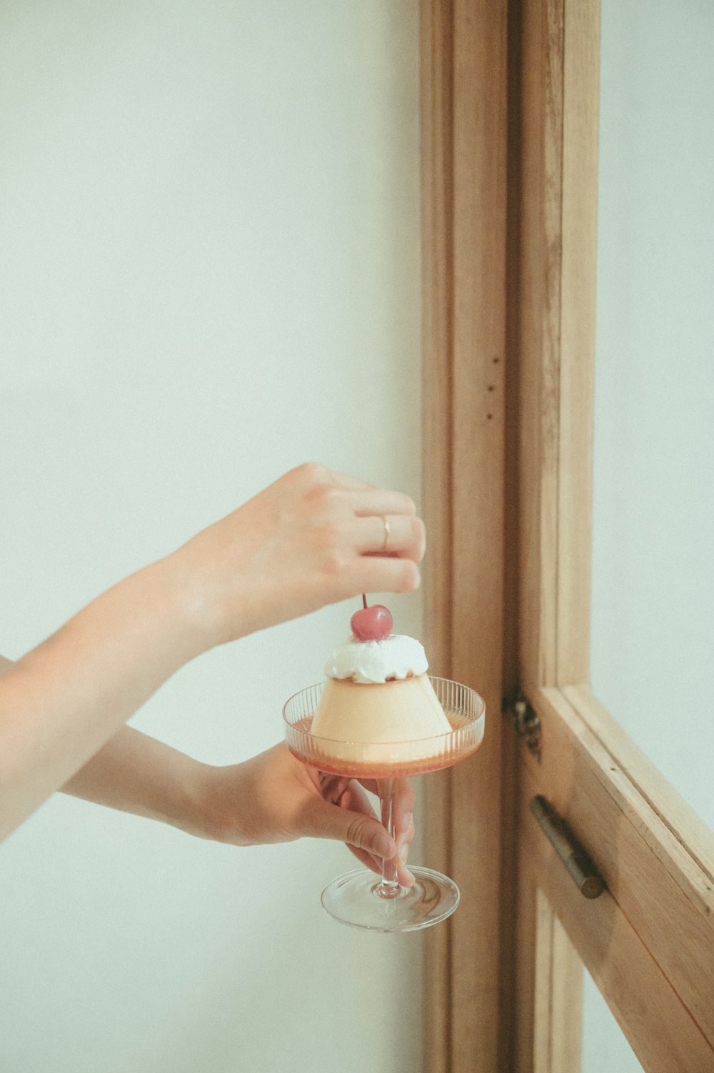 person holding pink and white plastic toy