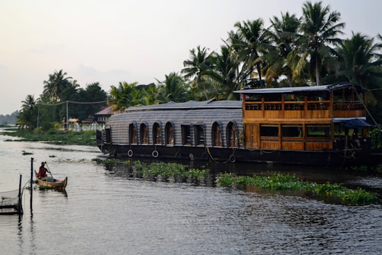 brown and white concrete building near body of water during daytime in Alleppey India