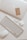 white apple keyboard with white earbuds