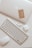 white apple keyboard with white earbuds
