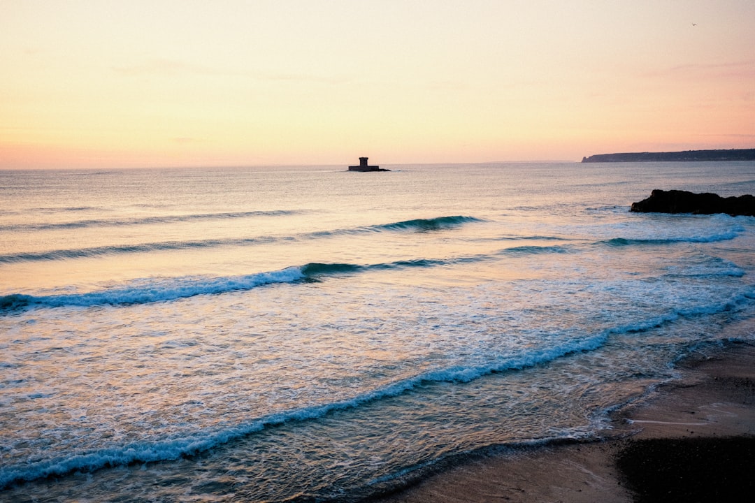 person surfing on sea waves during daytime