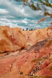 brown rocky mountain under cloudy sky during daytime