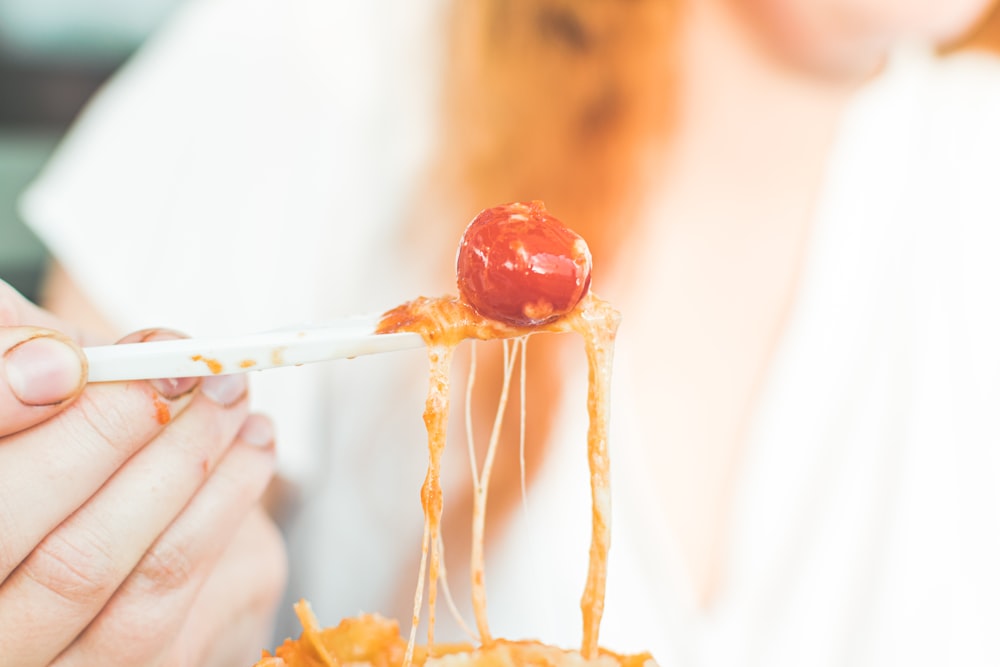 person holding red cherry fruit