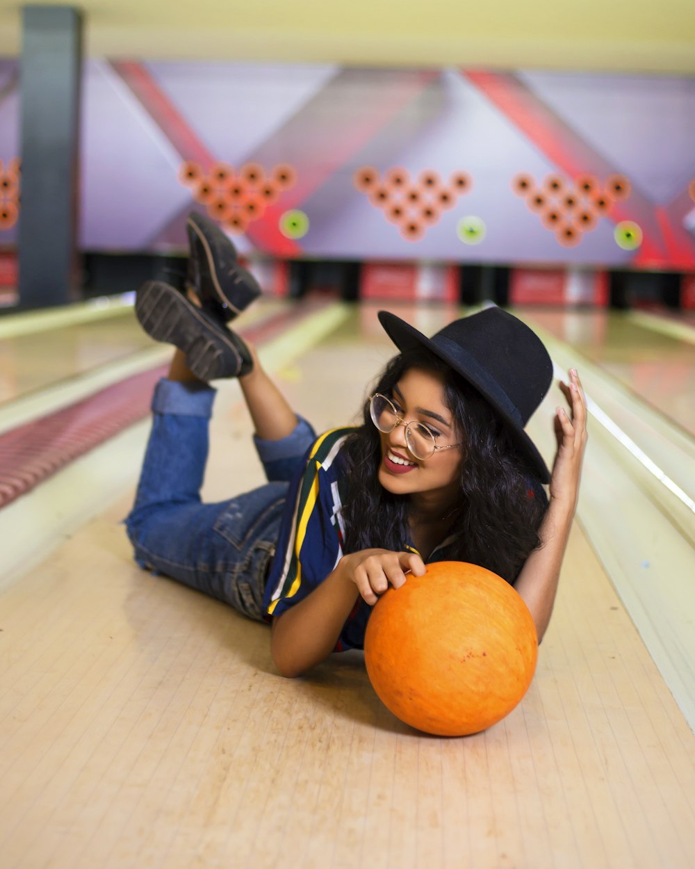 girl in blue and white school uniform holding orange pumpkin