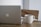 Close-up of a sleek business card resting on a wooden desk next to a laptop and coffee cup.