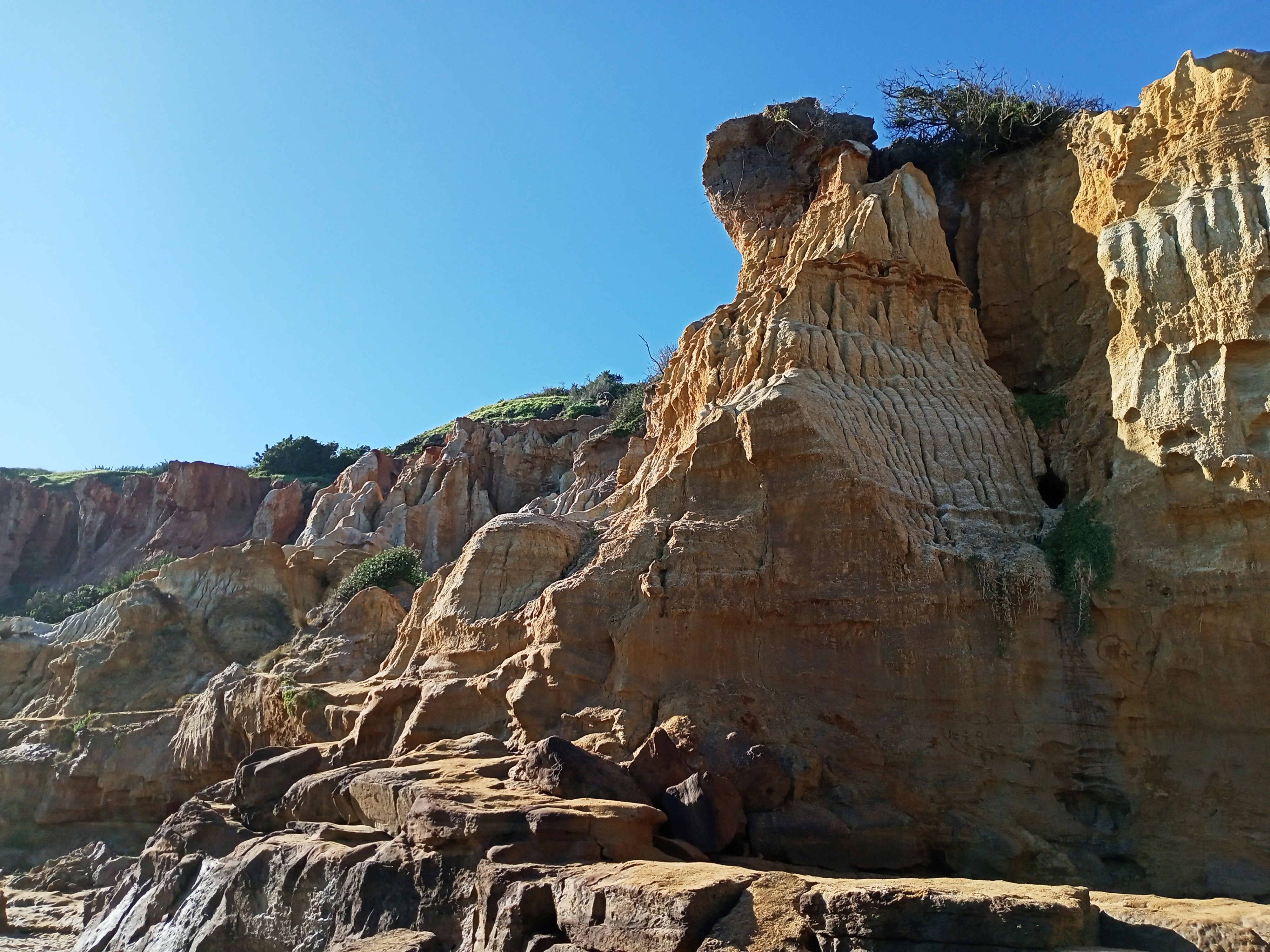brown rocky mountain under blue sky during daytime