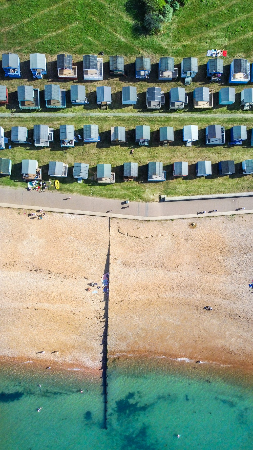 black and white plastic chairs on brown sand