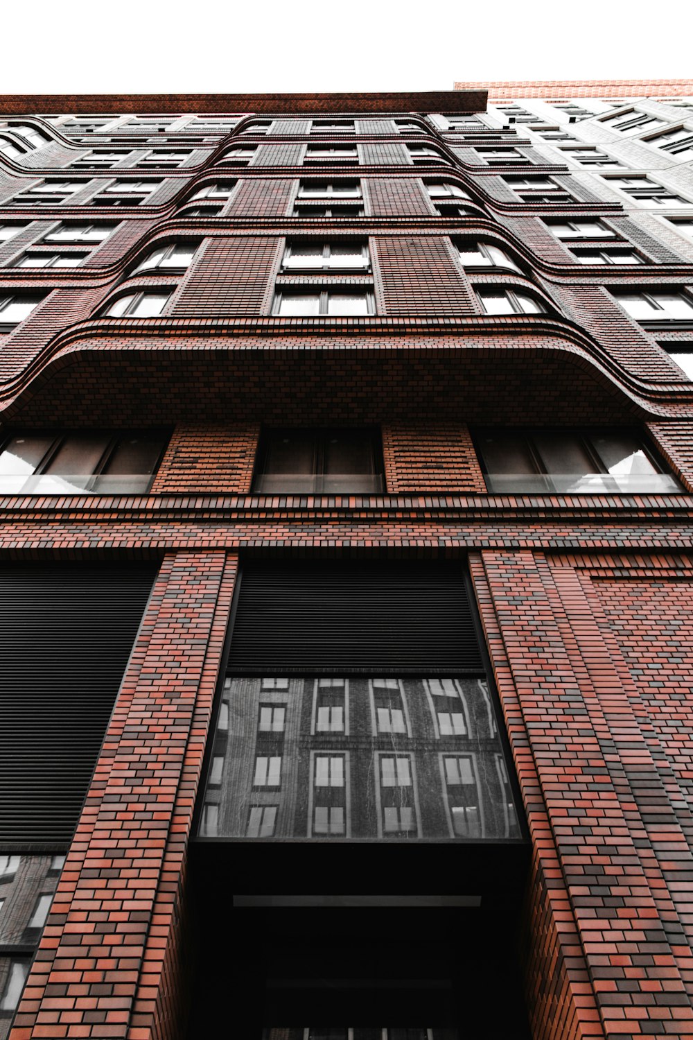 a tall red brick building with lots of windows