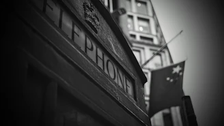 Close-up of Moroccan mosaic tiles next to a classic British red telephone box, symbolizing cultural fusion