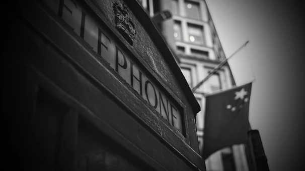 Close-up of Moroccan mosaic tiles next to a classic British red telephone box, symbolizing cultural fusion
