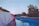 Smiling middle-aged man enjoying the outdoor pool at sunset