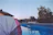 Smiling middle-aged man enjoying the outdoor pool at sunset