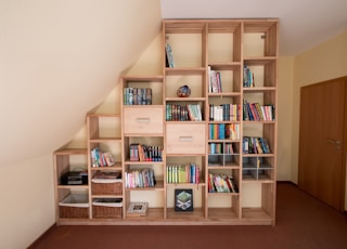 brown wooden shelf with books