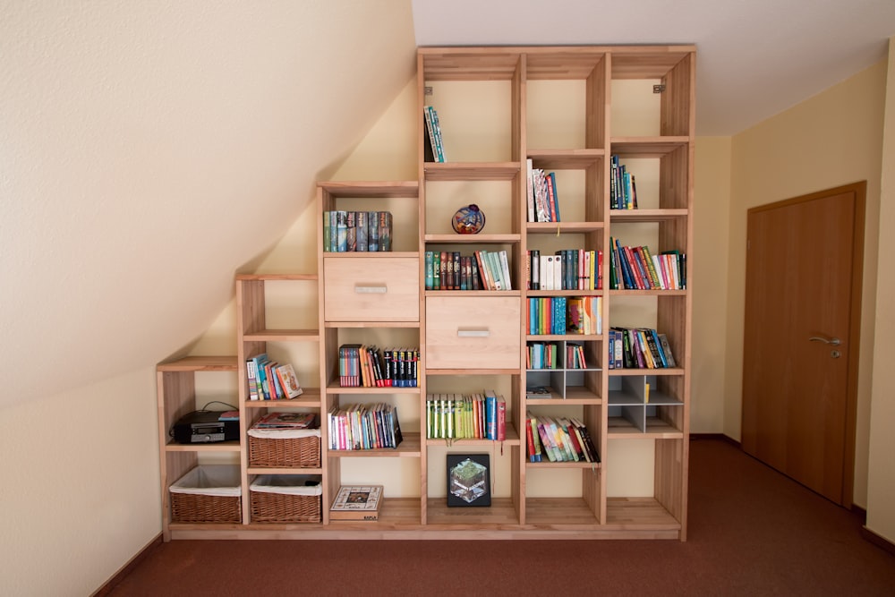 brown wooden shelf with books