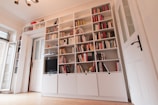 white wooden book shelves with books