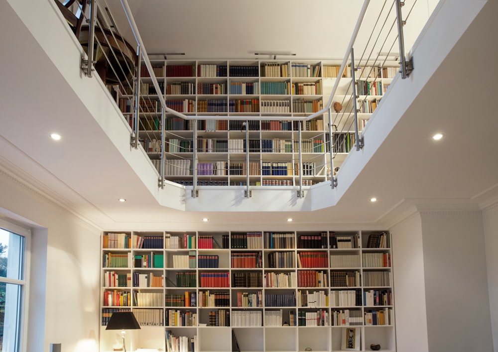 white wooden book shelves with books