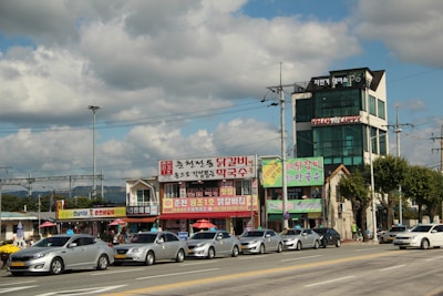 A bustling car export yard in Seoul with rows of shiny used cars ready for shipment.