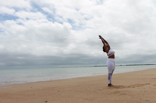 woman in white long sleeve shirt and white pants standing on beach shore during daytime in Vendée France