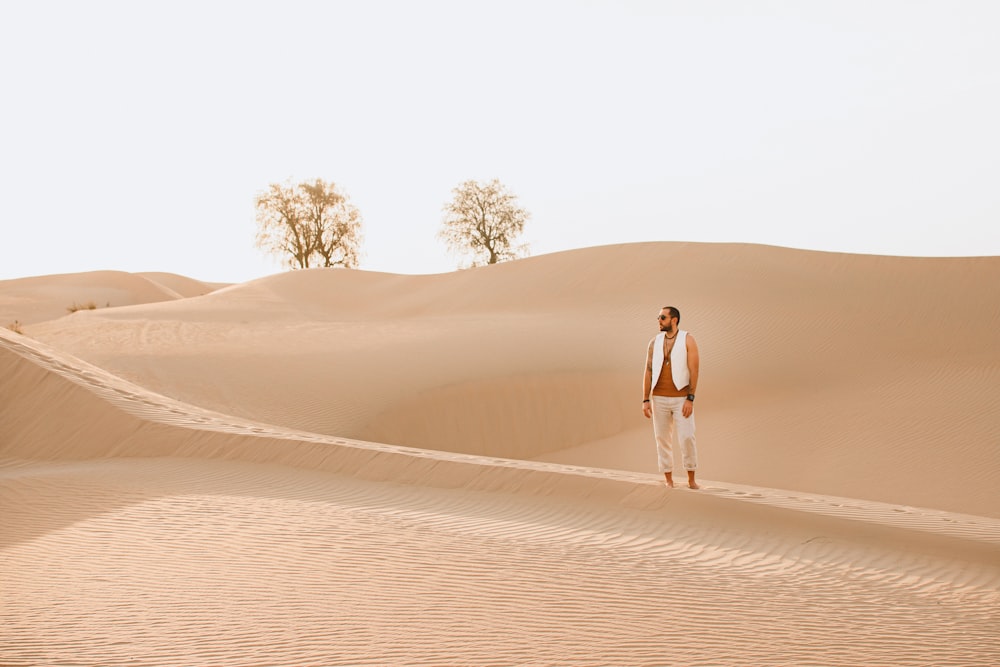 man and woman walking on desert during daytime