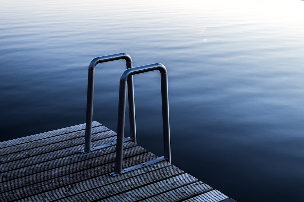 gray wooden dock on body of water