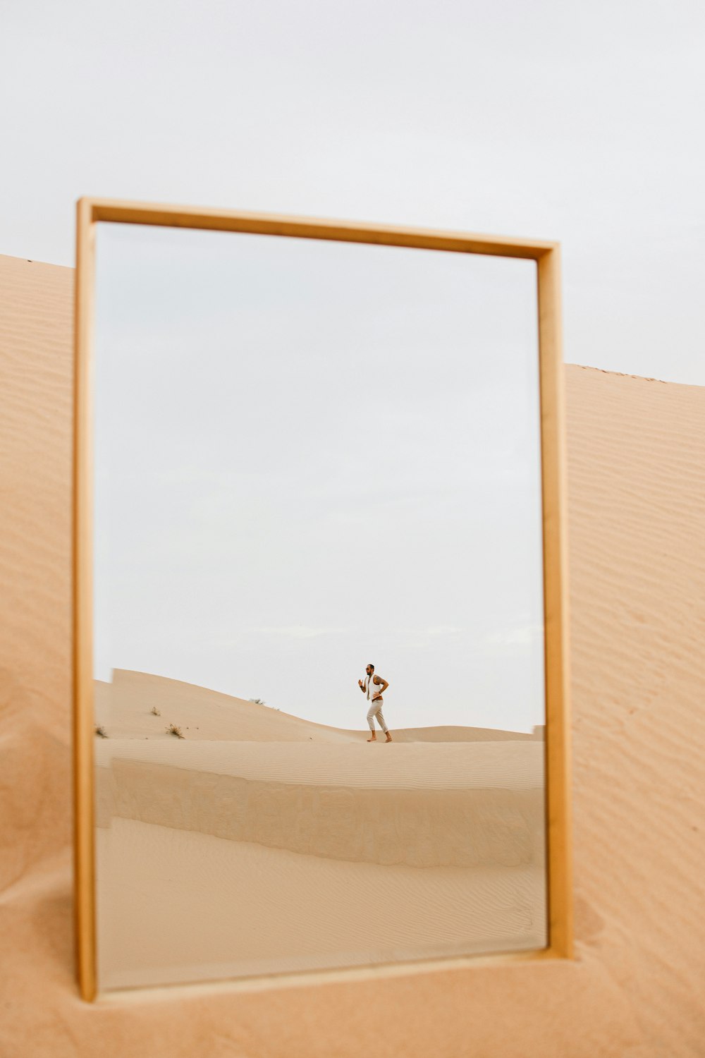 person walking on white sand during daytime