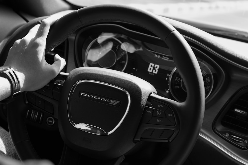 person holding black honda steering wheel