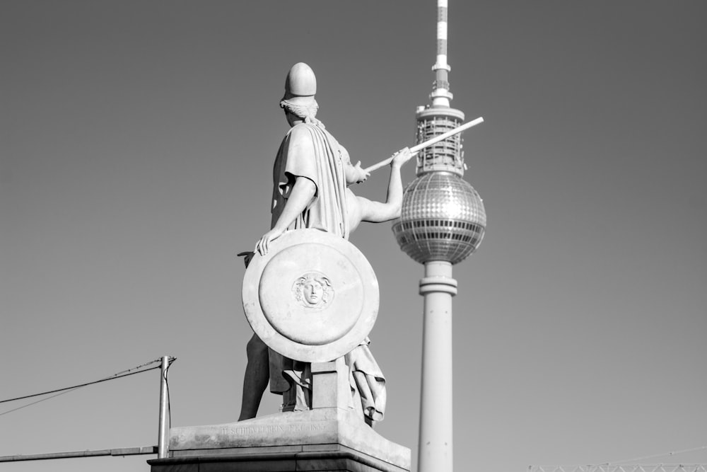 statue of man holding book statue