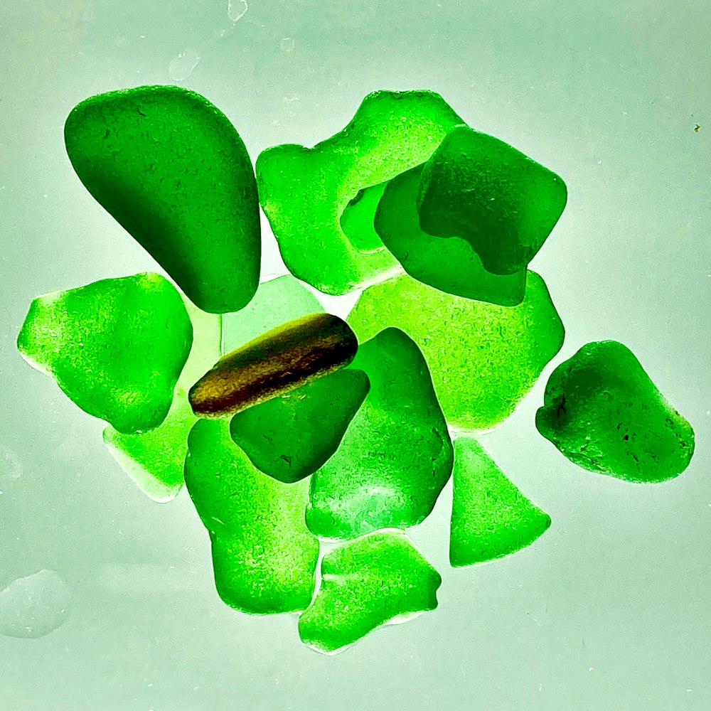 green heart shaped stone on white surface