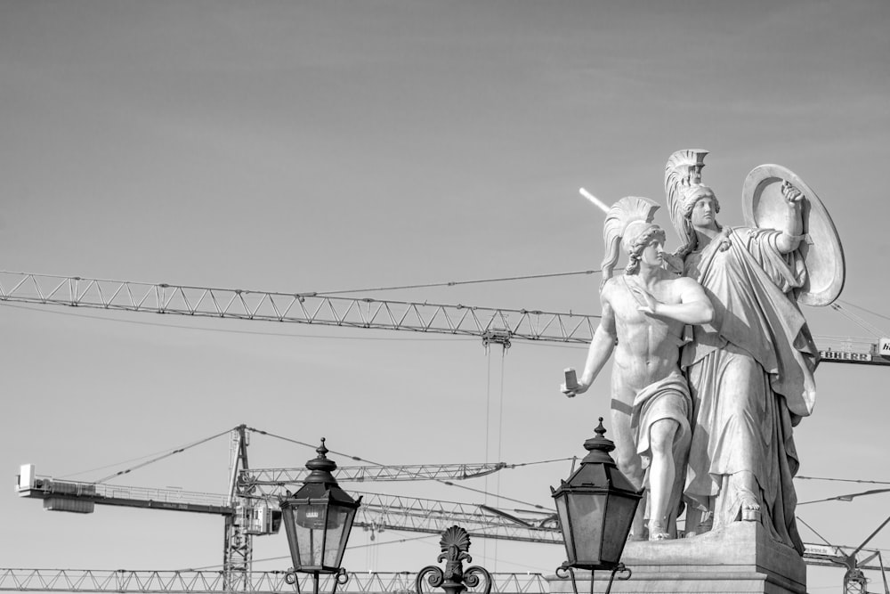 grayscale photo of man riding horse statue