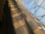 Warm amber light illuminating the delicate weaving pattern created by wovenstrong’s new technology.