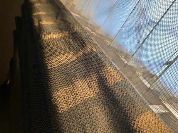 The early prototype machine of wovenstrong casting strands of material into complex shapes under subtle lighting.